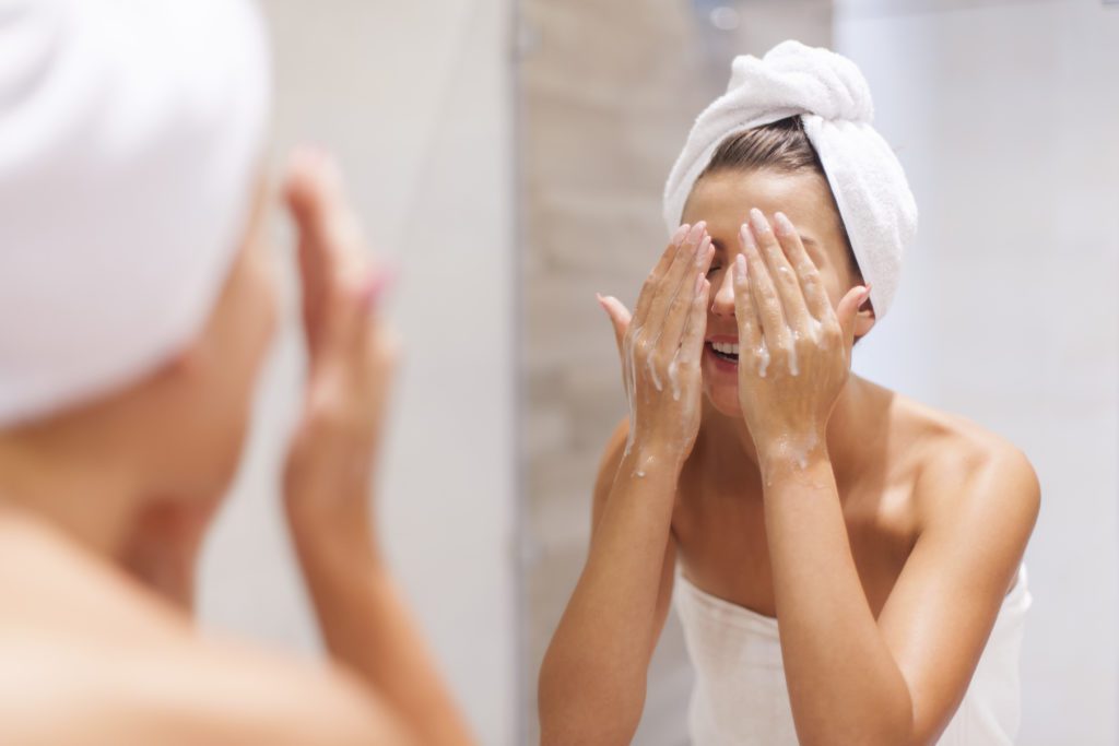 woman washing her face